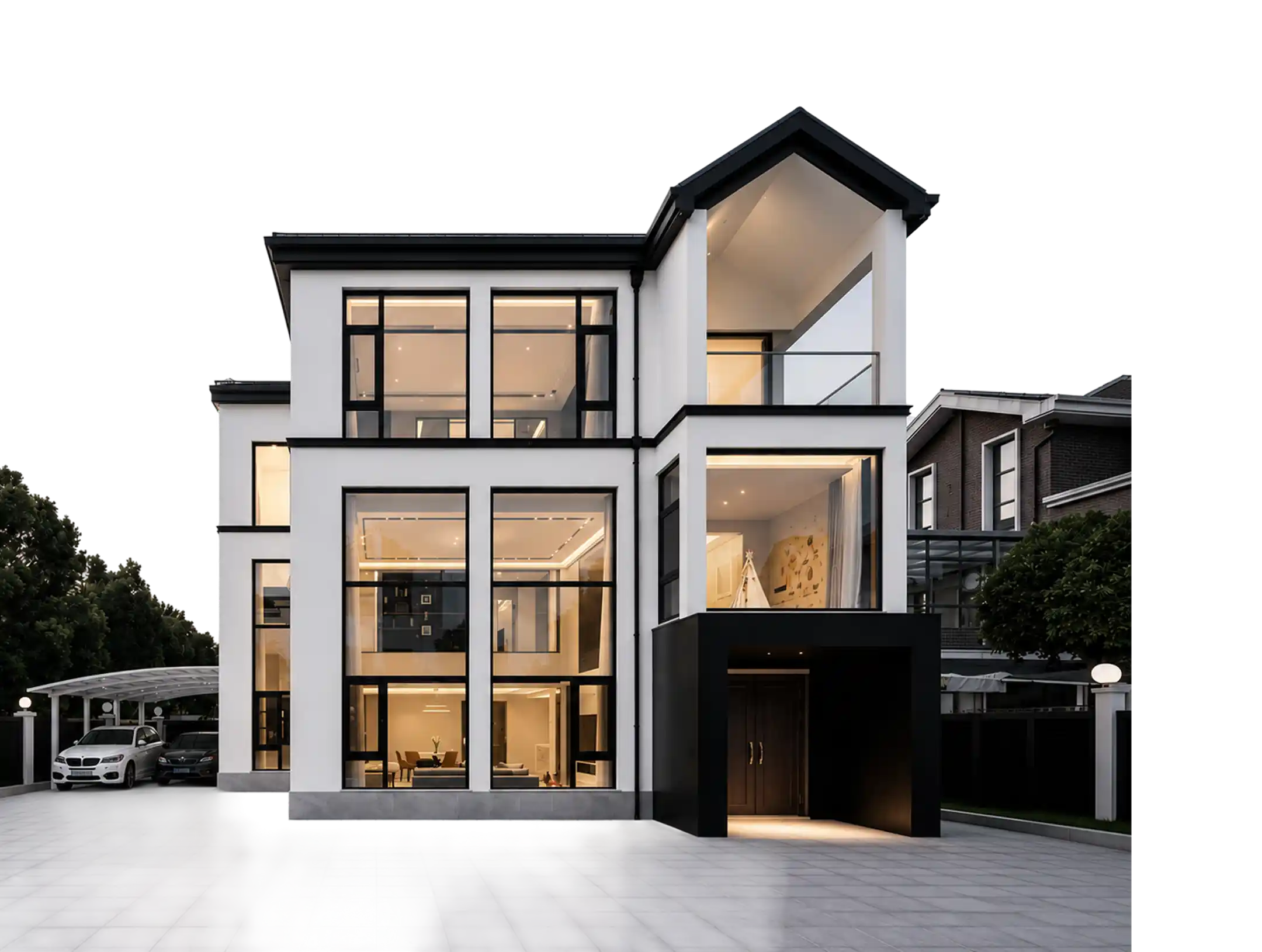 Modern three-story white house with large black-framed windows, a flat paved driveway, and a covered entrance illuminated at night, with two cars parked under a transparent canopy on the left and adjacent houses partly visible.